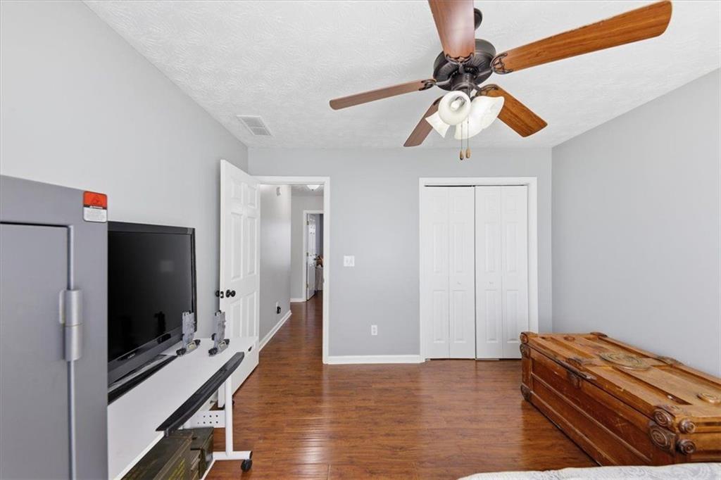 493 Youth Jersey Road Covington, GA 30014 - Photo 24 of 52 a living room with furniture and a flat screen tv