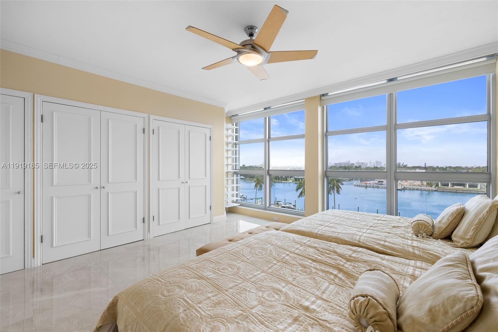 5055 Collins Avenue, Unit 6M Miami Beach, FL 33140 - Photo 16 of 42 a bedroom with a large bed and a large window