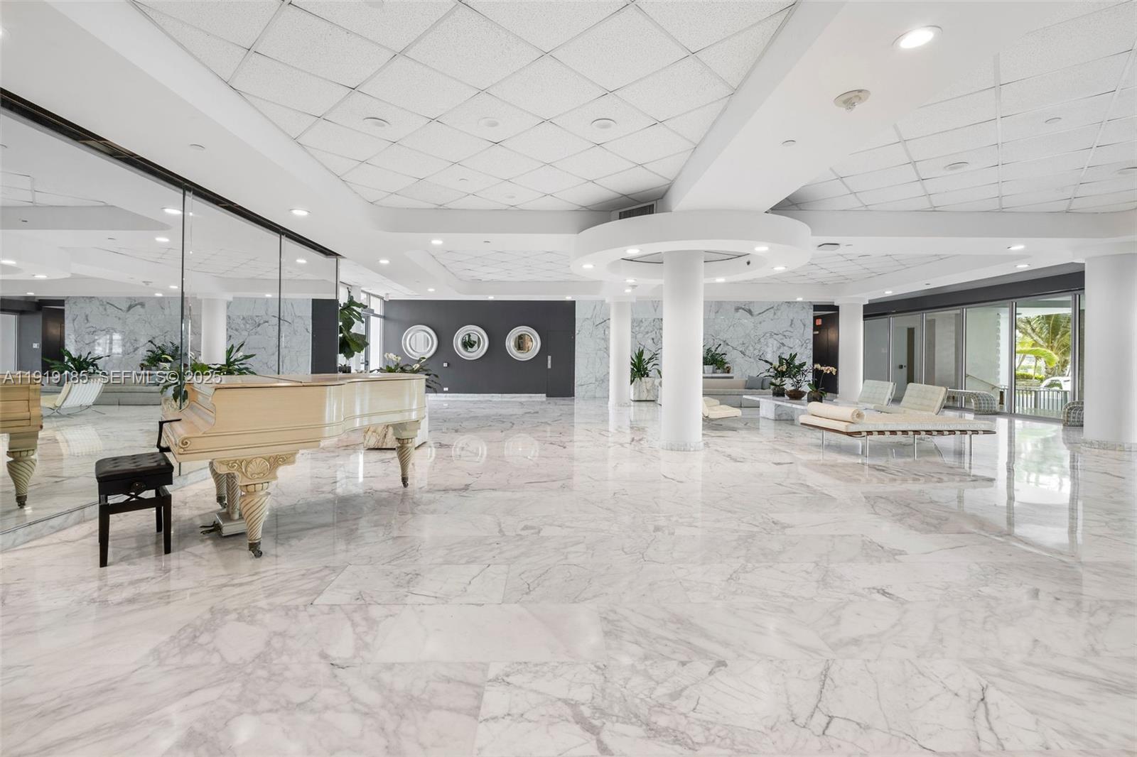 5055 Collins Avenue, Unit 6M Miami Beach, FL 33140 - Photo 25 of 42 a view of a lobby with furniture and a large window