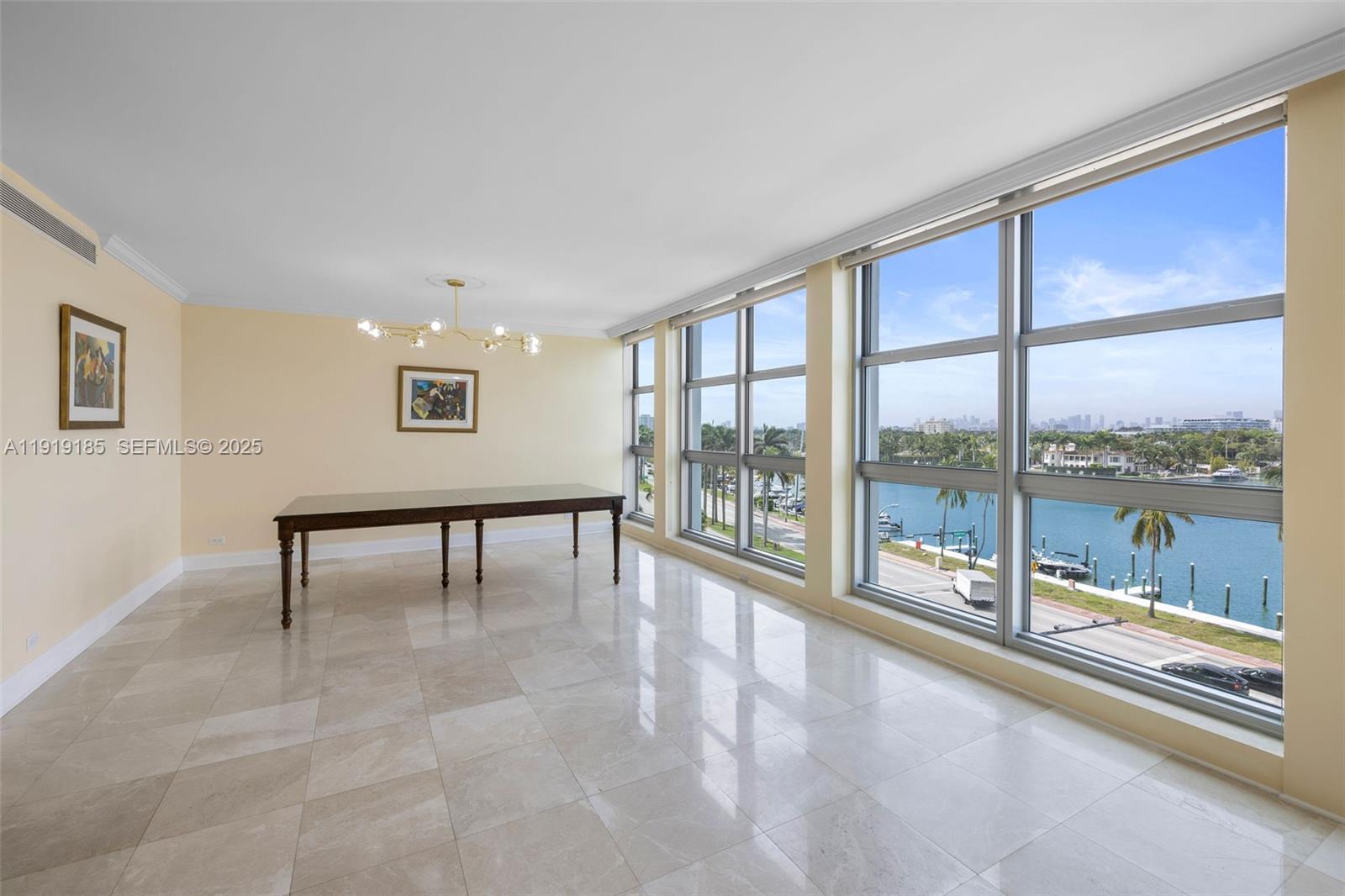 5055 Collins Avenue, Unit 6M Miami Beach, FL 33140 - Photo 3 of 42 a view of an empty room with a window and a swimming pool