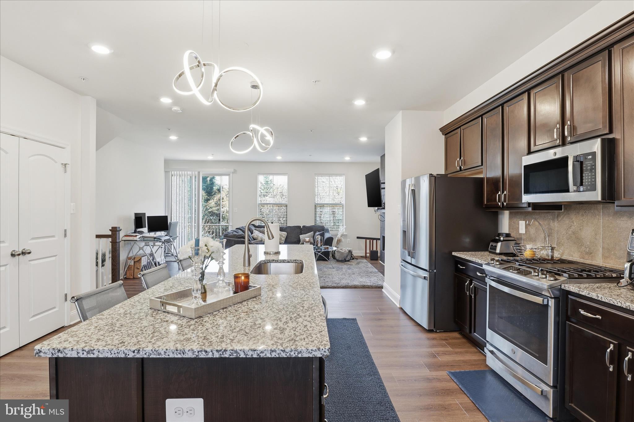 16416 Fife Way Bowie, MD 20716 - Photo 12 of 43 a kitchen with stainless steel appliances granite countertop a stove refrigerator and microwave
