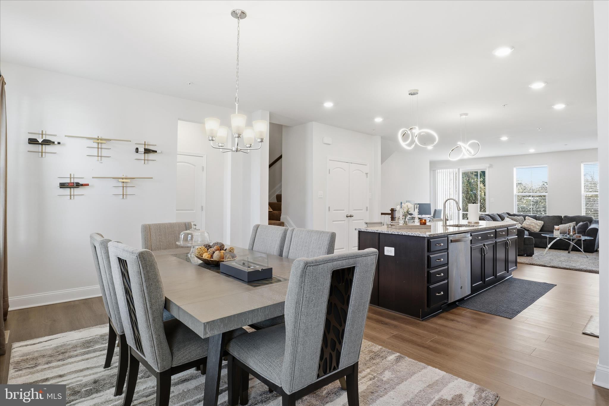 16416 Fife Way Bowie, MD 20716 - Photo 15 of 43 a view of a dining room and livingroom with furniture wooden floor a chandelier