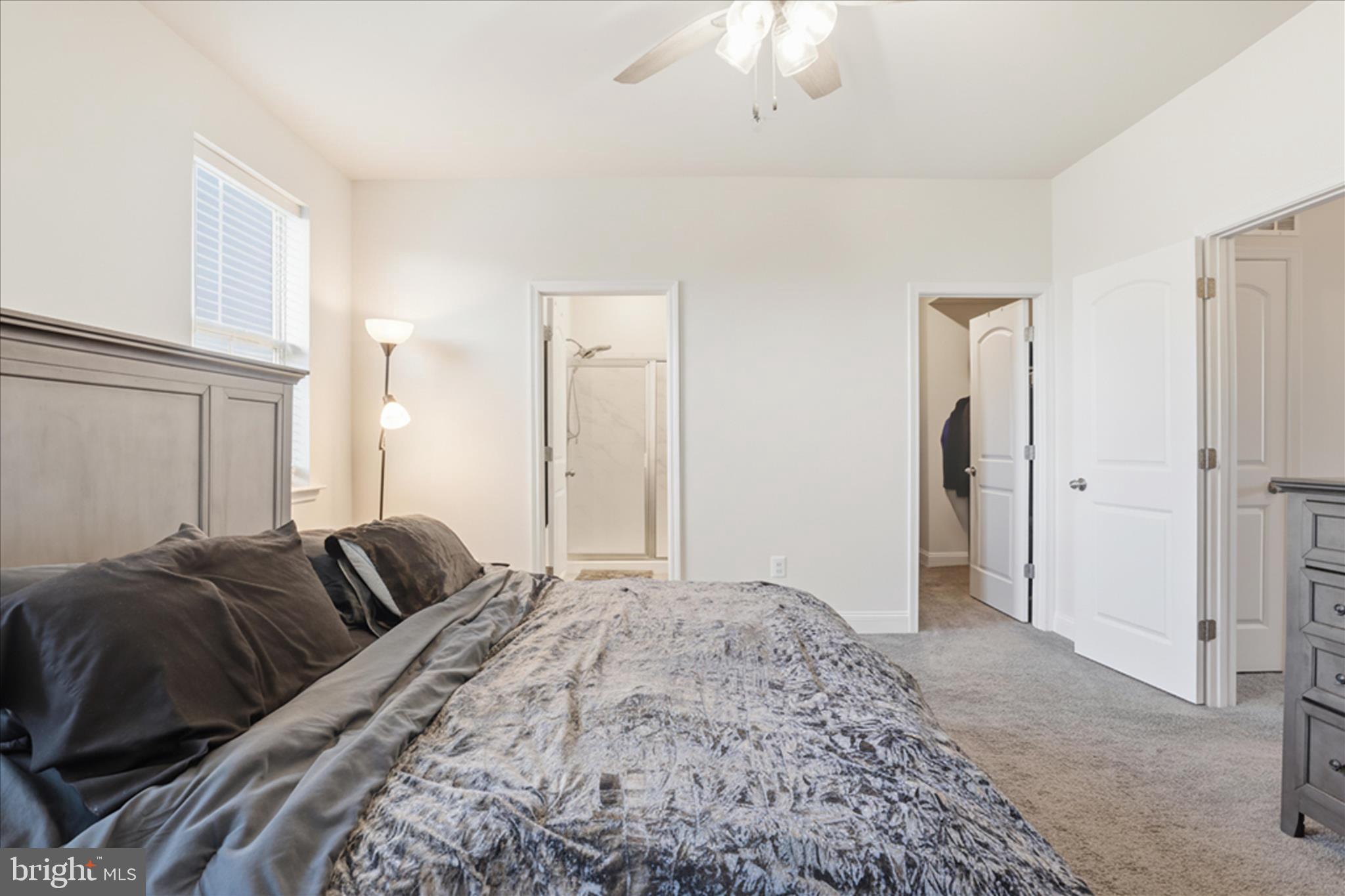 16416 Fife Way Bowie, MD 20716 - Photo 19 of 43 a bedroom with a bed and a chandelier