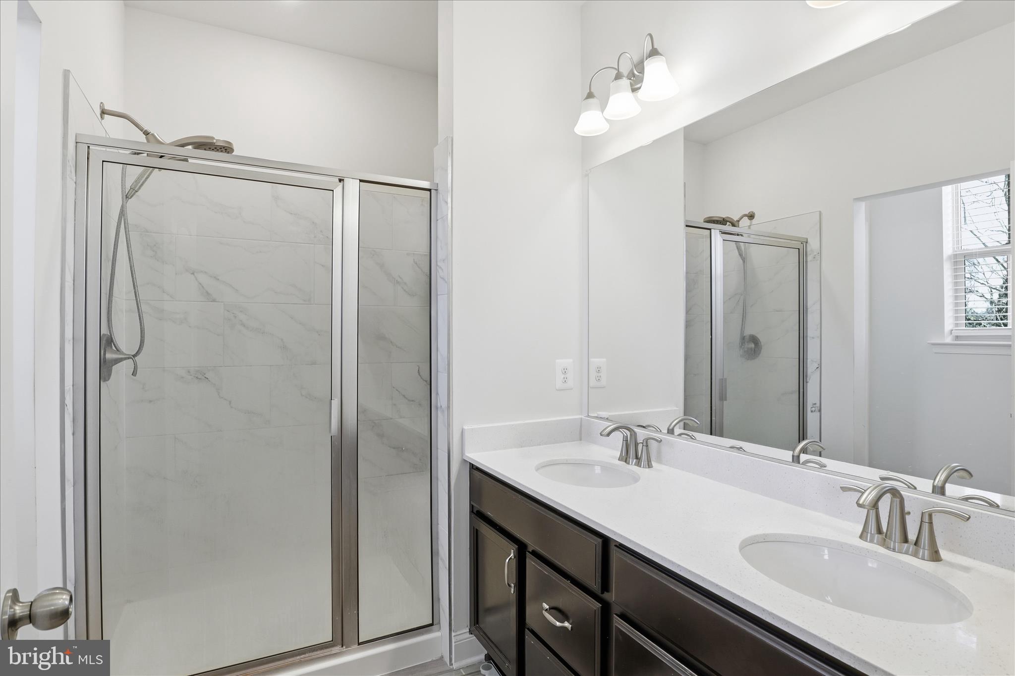 16416 Fife Way Bowie, MD 20716 - Photo 20 of 43 a bathroom with a double vanity sink mirror and shower