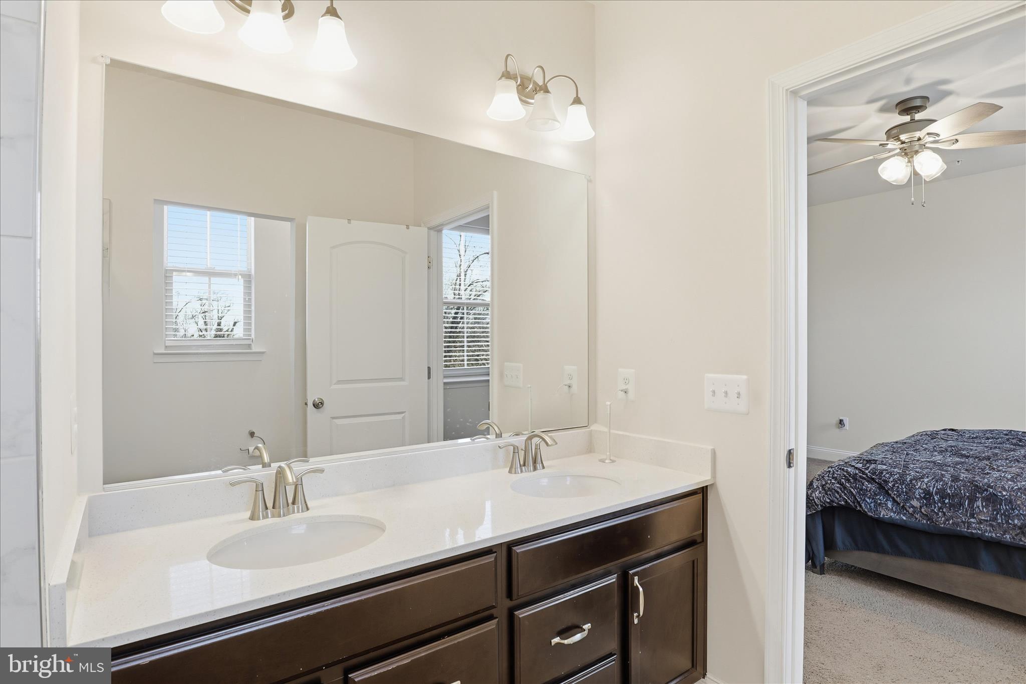 16416 Fife Way Bowie, MD 20716 - Photo 21 of 43 a en suite bathroom with a double vanity sink and a mirror