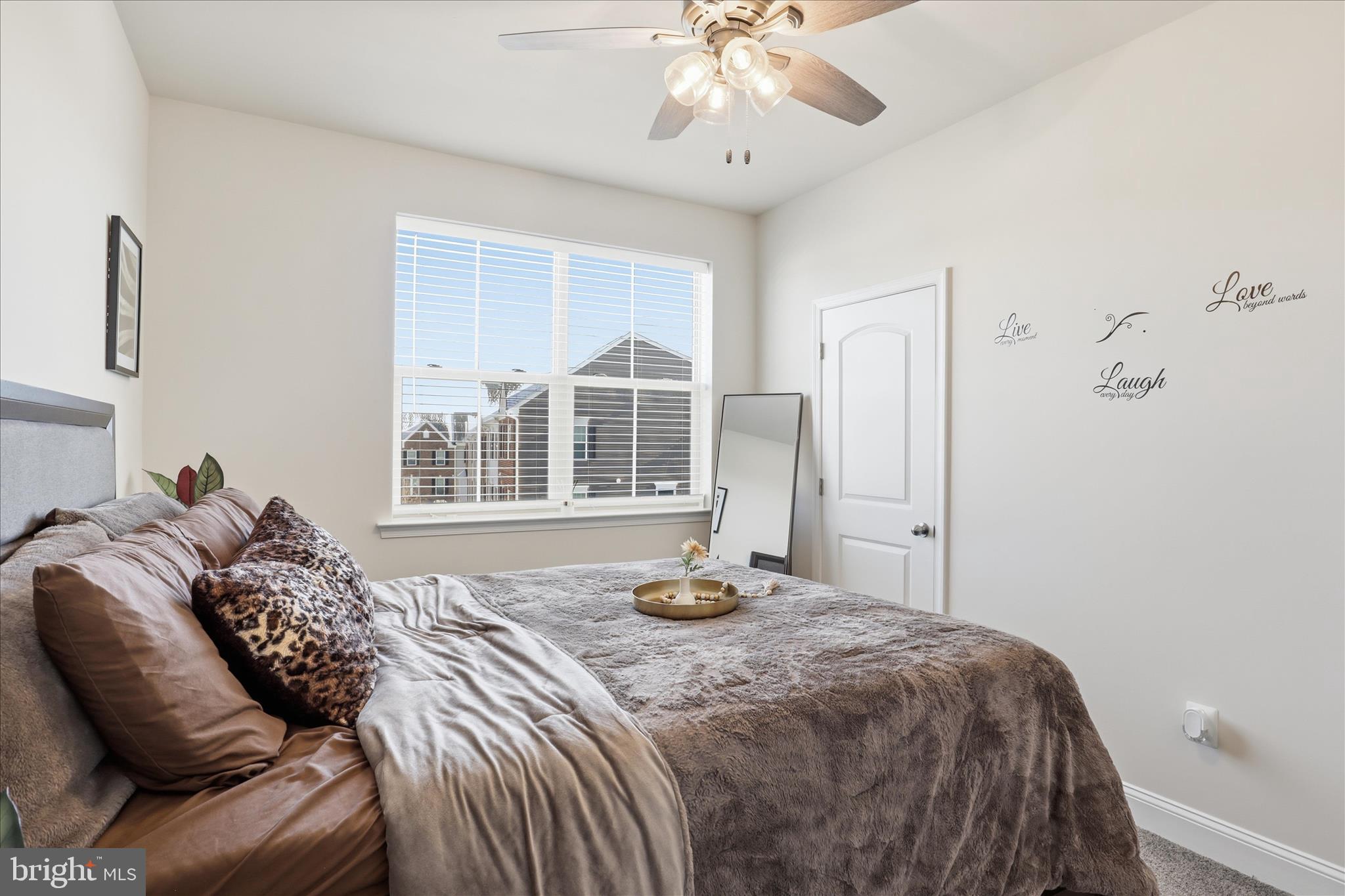 16416 Fife Way Bowie, MD 20716 - Photo 26 of 43 a bedroom with a large bed and a chandelier