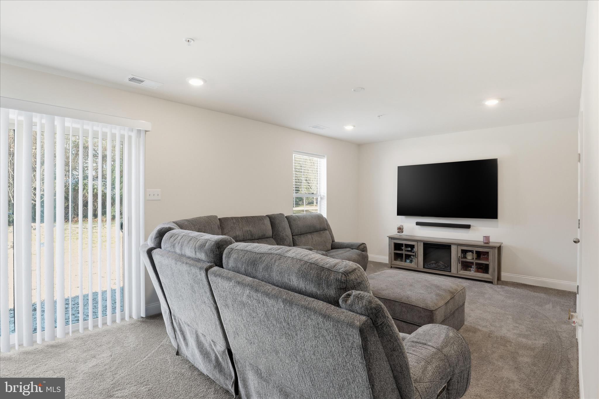 16416 Fife Way Bowie, MD 20716 - Photo 30 of 43 a living room with furniture and a flat screen tv