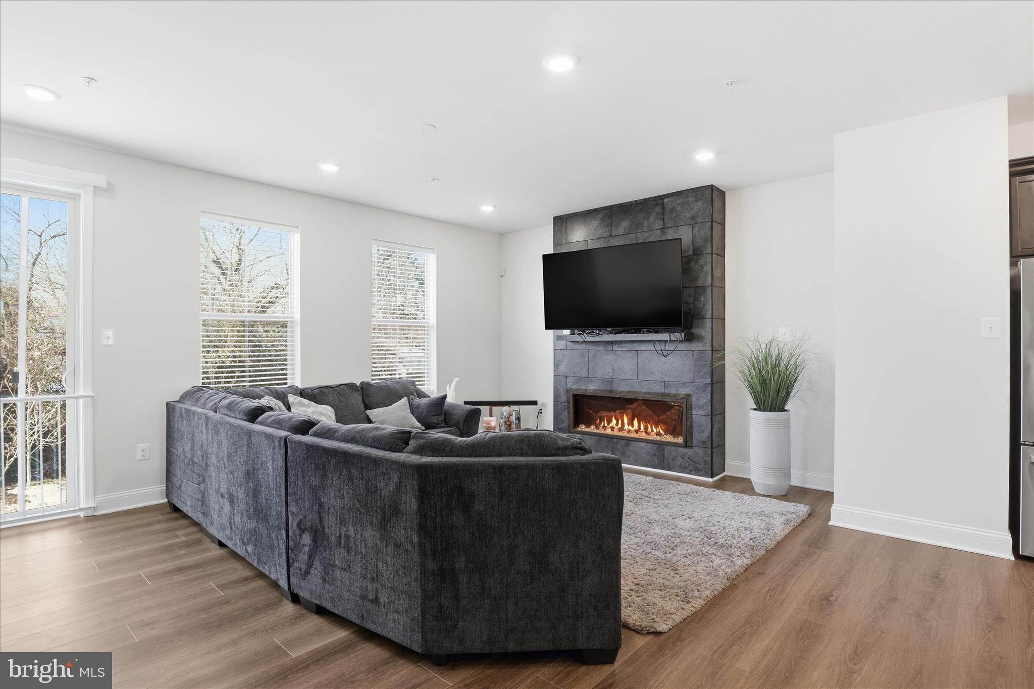 16416 Fife Way Bowie, MD 20716 - Photo 6 of 43 a living room with furniture a fireplace and a flat screen tv