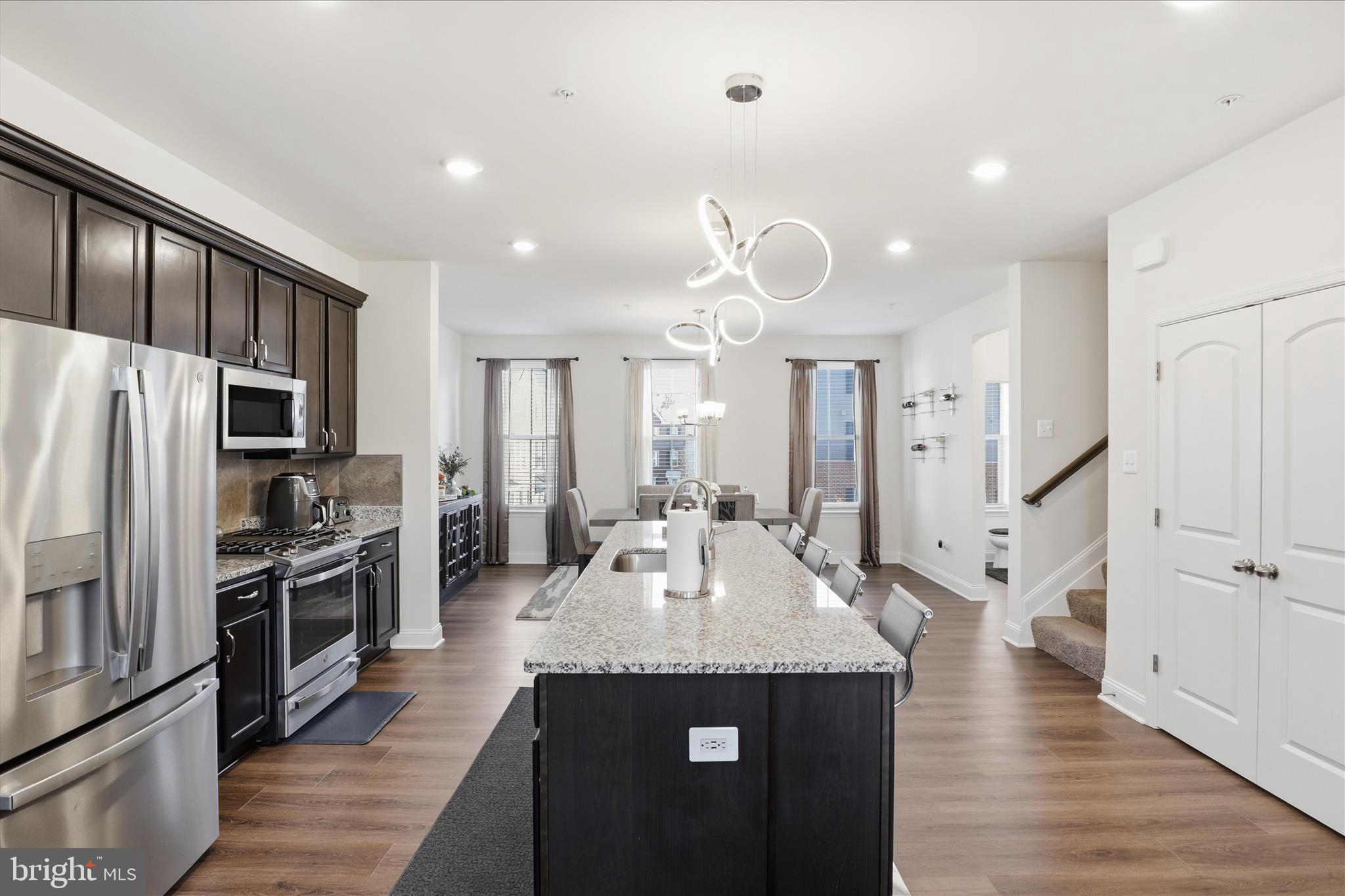 16416 Fife Way Bowie, MD 20716 - Photo 10 of 43 a kitchen with stainless steel appliances granite countertop a refrigerator a stove a sink dishwasher and a refrigerator with wooden floor