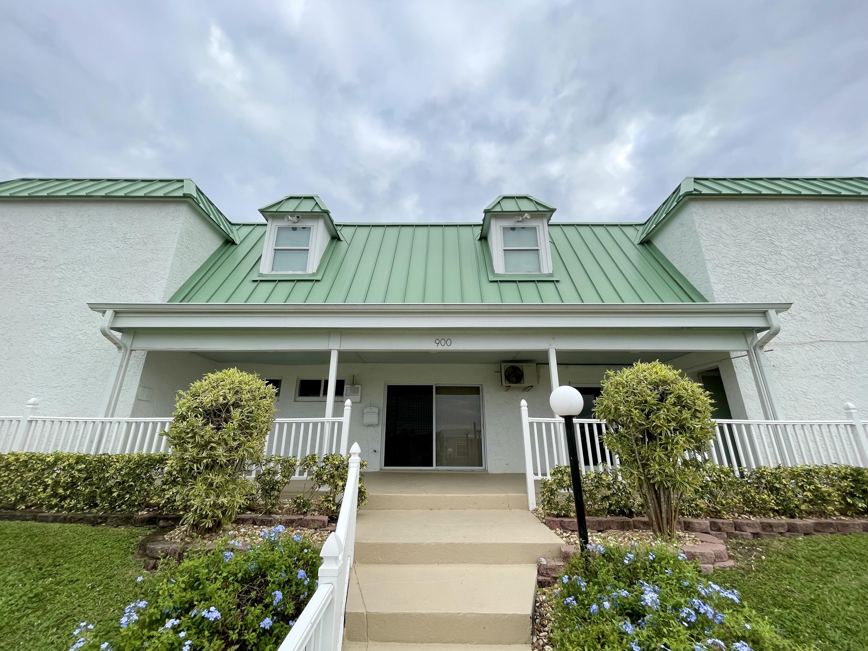 900 Juno Ocean Walk, Unit C34 Juno Beach, FL 33408 - Photo 13 of 20 a front view of a house with garden