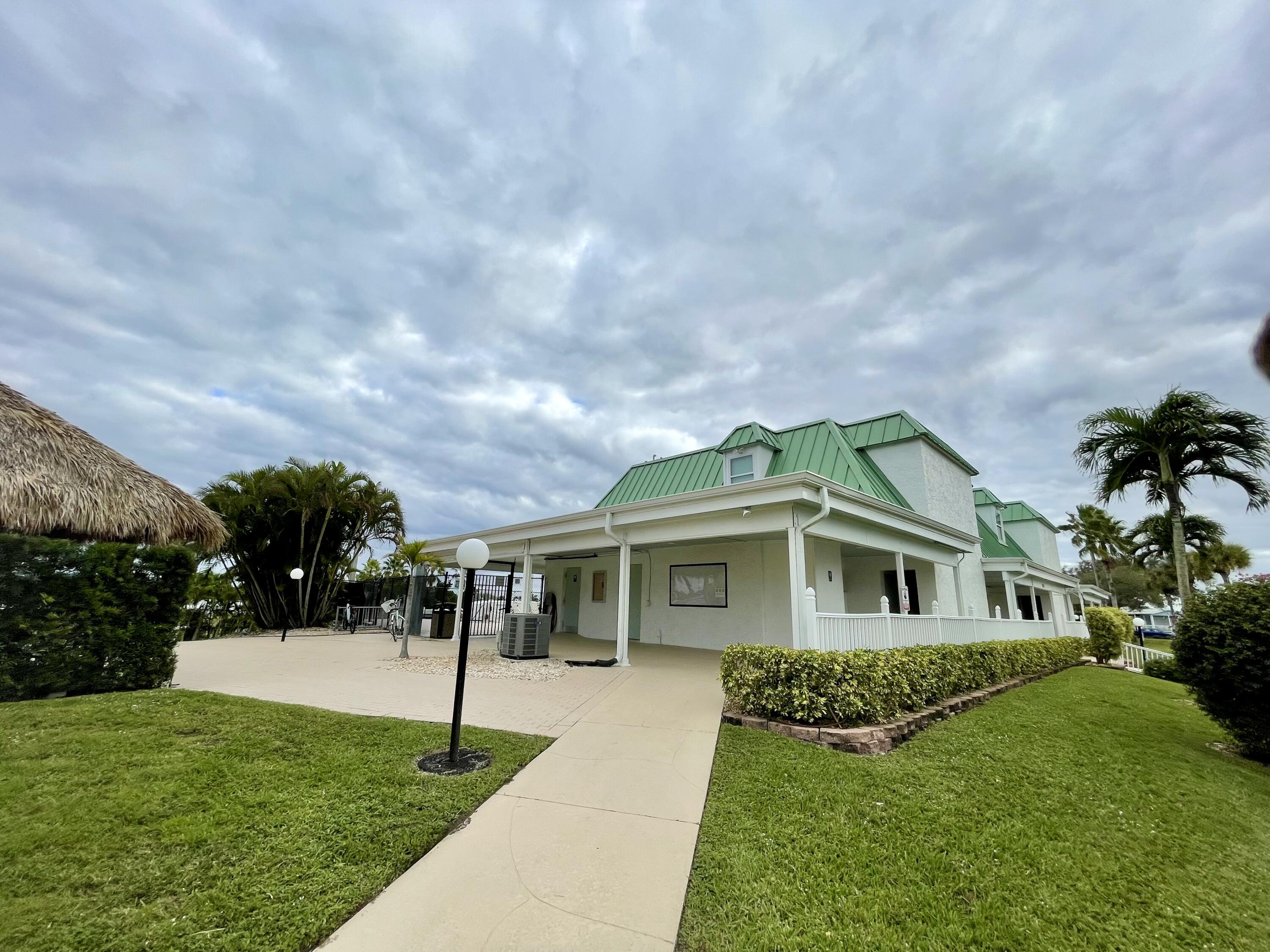 900 Juno Ocean Walk, Unit C34 Juno Beach, FL 33408 - Photo 14 of 20 a front view of a house with a yard and trees