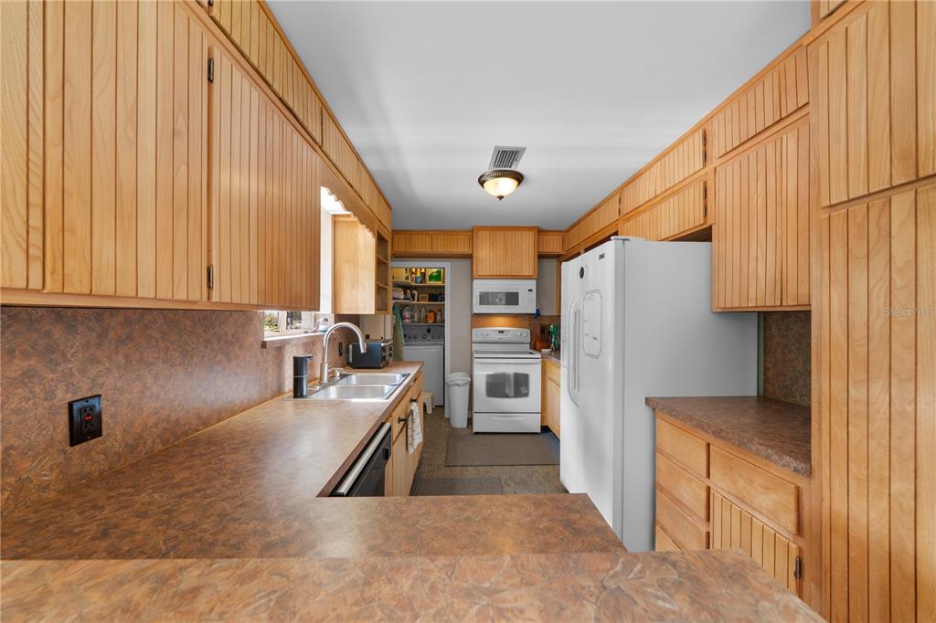 2002 Northwest 11th Road Gainesville, FL 32605 - Photo 20 of 53 a kitchen with refrigerator and cabinets