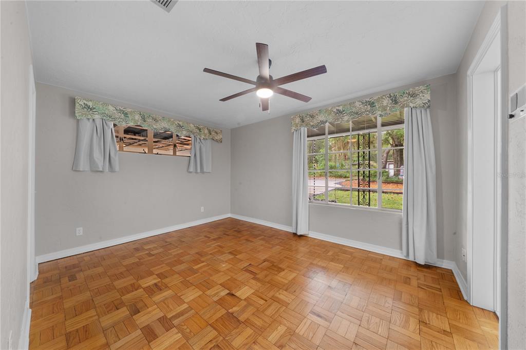 2002 Northwest 11th Road Gainesville, FL 32605 - Photo 23 of 53 a view of a big room with windows and chandelier fan