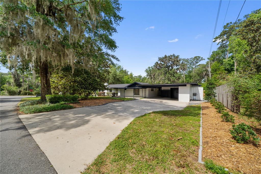2002 Northwest 11th Road Gainesville, FL 32605 - Photo 37 of 53 a front view of a house with a yard and trees