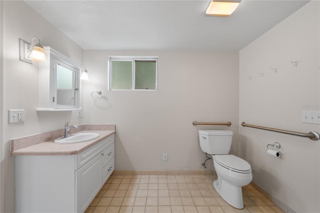 2002 Northwest 11th Road Gainesville, FL 32605 - Photo 43 of 53 a bathroom with a sink toilet and a mirror