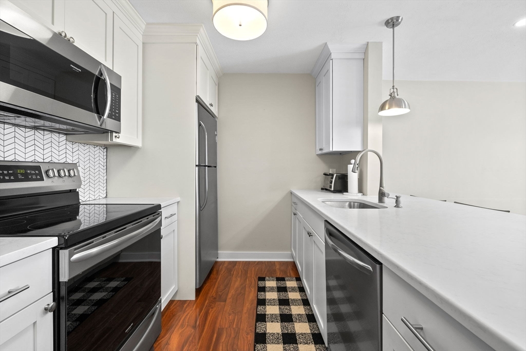 a kitchen with a sink and stainless steel appliances