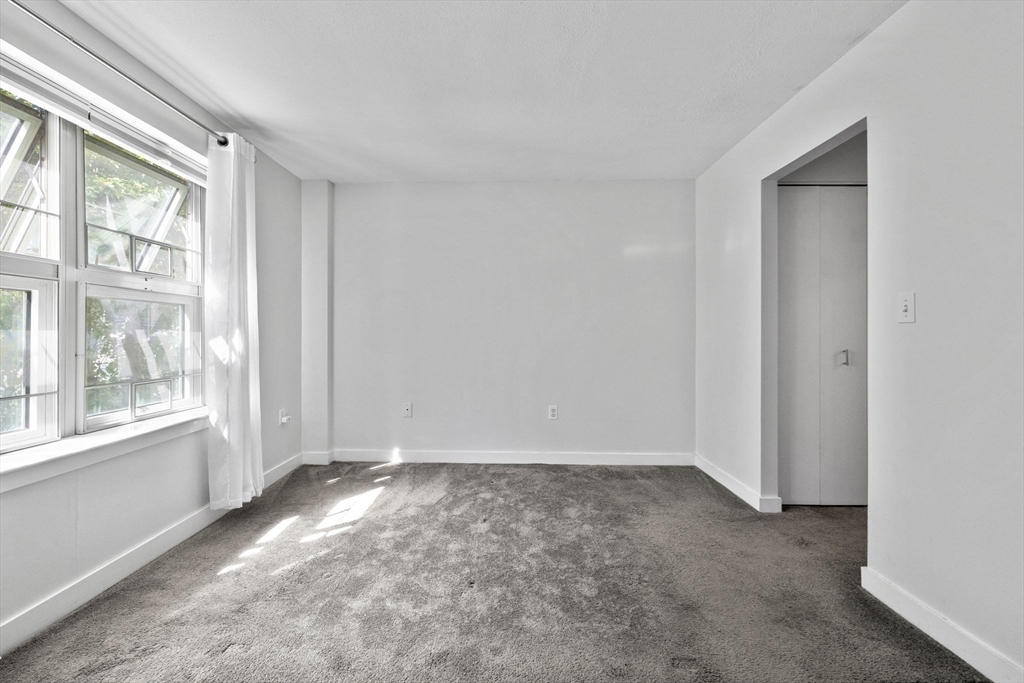 269 Cambridge Road, Unit 203 Woburn, MA 01801 - Photo 12 of 26 a view of an empty room with a window