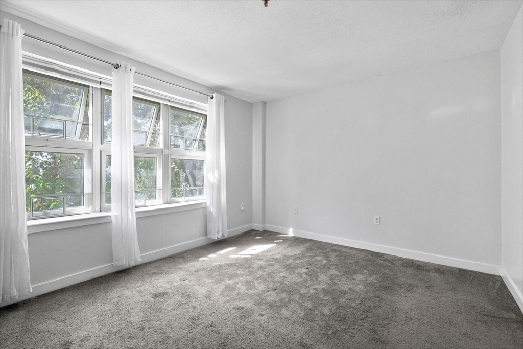 269 Cambridge Road, Unit 203 Woburn, MA 01801 - Photo 13 of 26 an empty room with windows