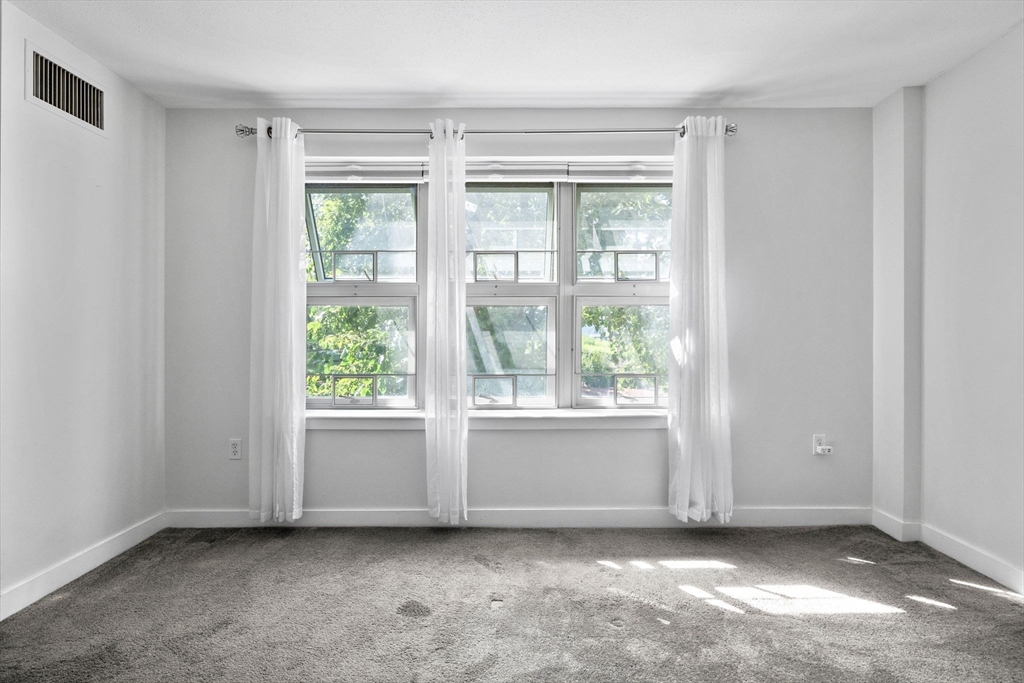 269 Cambridge Road, Unit 203 Woburn, MA 01801 - Photo 14 of 26 a view of an empty room with a window