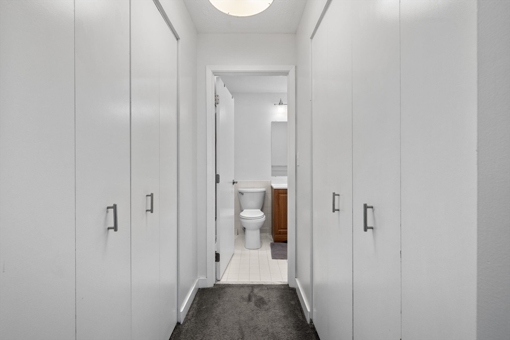 269 Cambridge Road, Unit 203 Woburn, MA 01801 - Photo 15 of 26 a view of a bathroom from a hallway