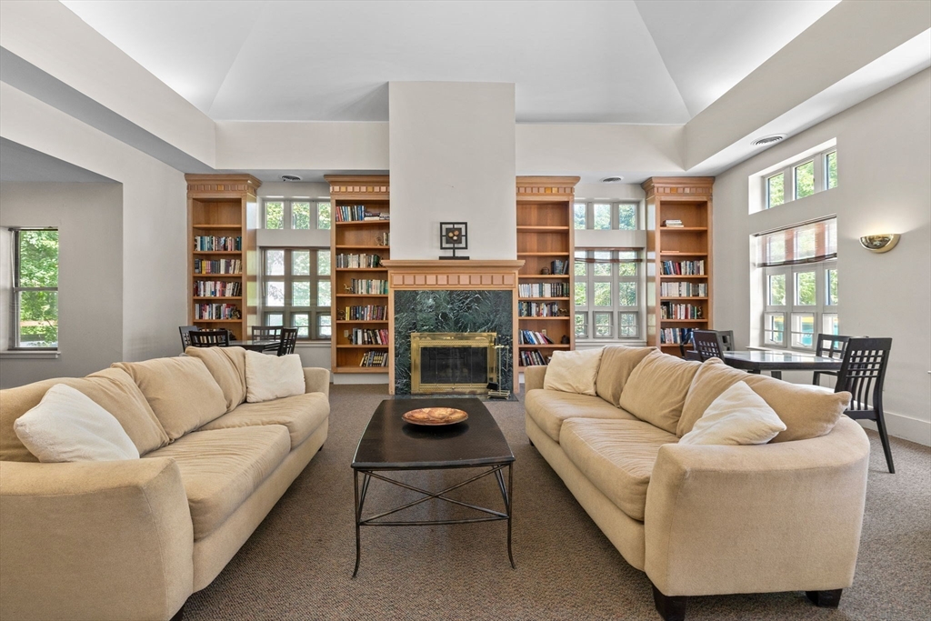 269 Cambridge Road, Unit 203 Woburn, MA 01801 - Photo 20 of 26 a living room with furniture fireplace and a large window
