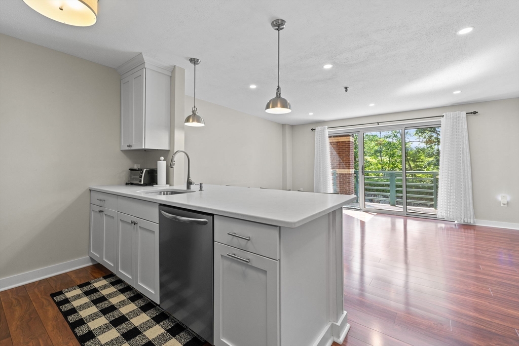 269 Cambridge Road, Unit 203 Woburn, MA 01801 - Photo 2 of 26 a kitchen with a sink window and cabinets