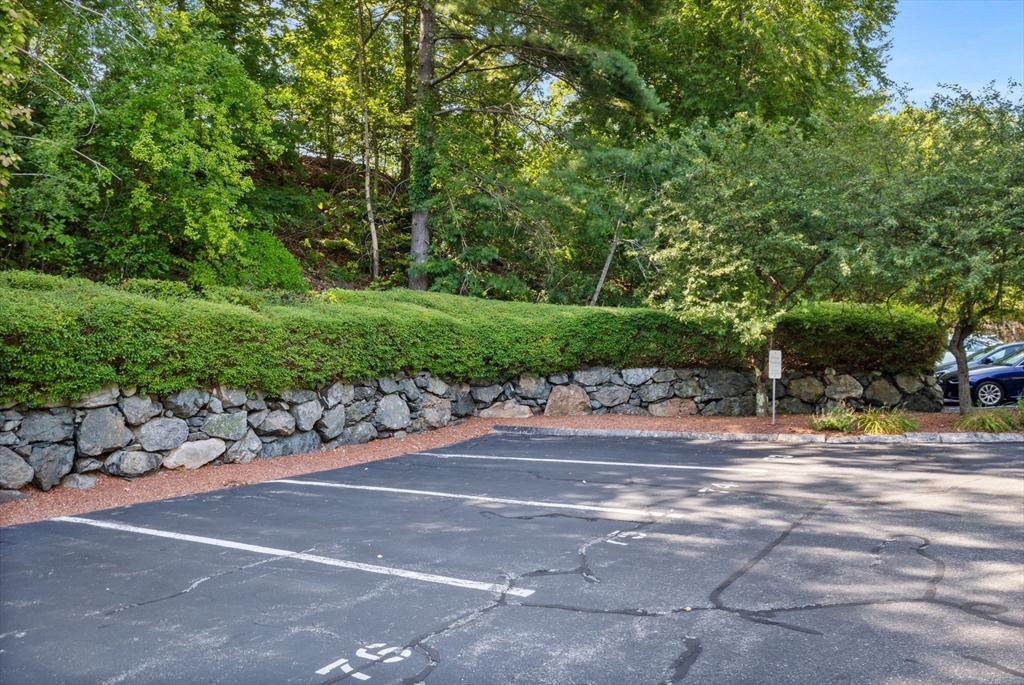 269 Cambridge Road, Unit 203 Woburn, MA 01801 - Photo 24 of 26 a view of a yard with cars parked