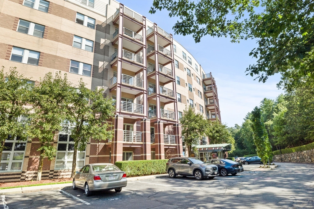 269 Cambridge Road, Unit 203 Woburn, MA 01801 - Photo 26 of 26 a car parked in front of brick building