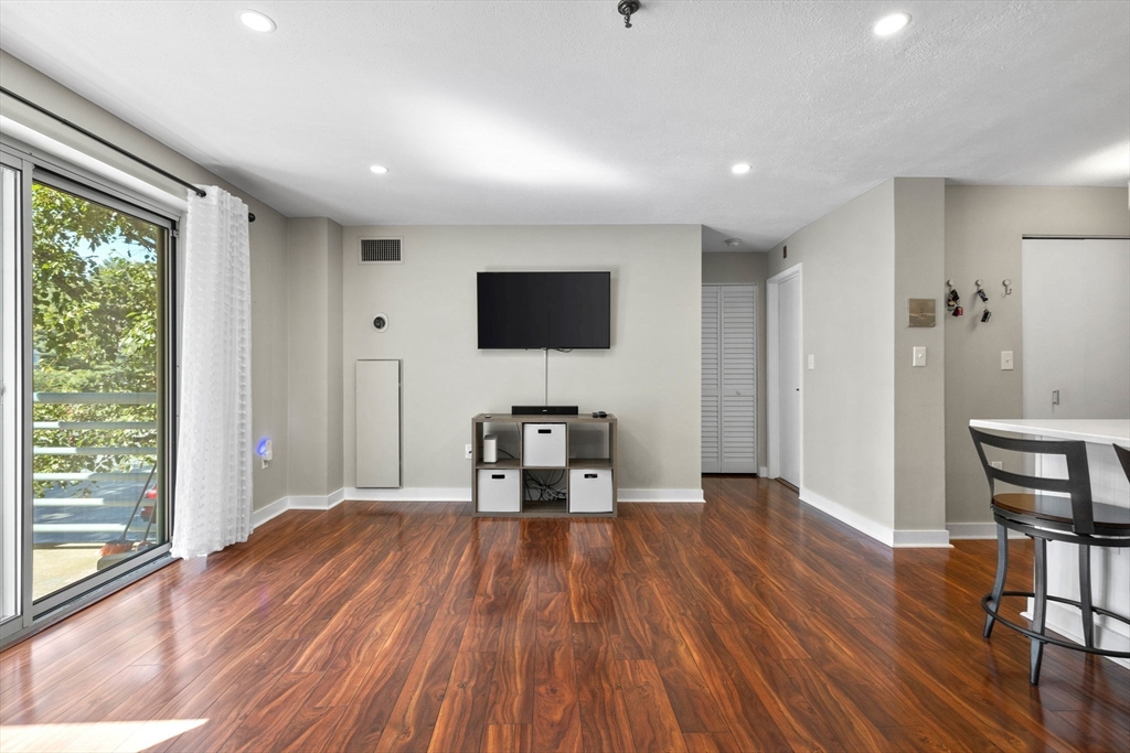 269 Cambridge Road, Unit 203 Woburn, MA 01801 - Photo 7 of 26 a view of a livingroom with furniture and a flat screen tv