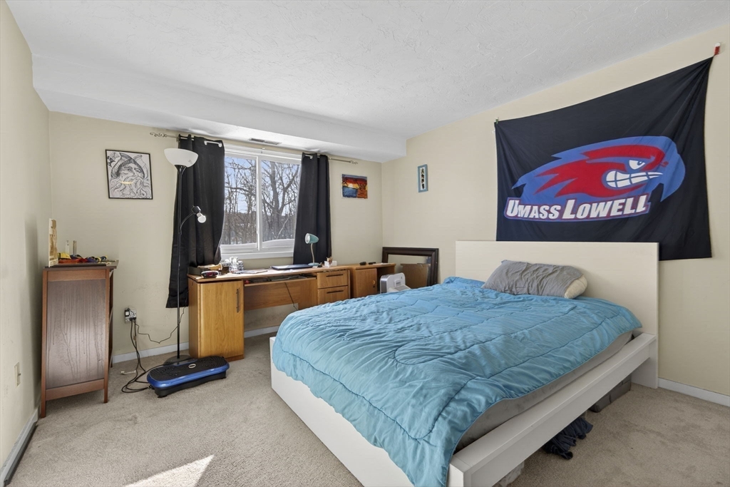 189 Littleton Road, Unit 59 Chelmsford, MA 01824 - Photo 12 of 17 a bedroom with a bed and dresser