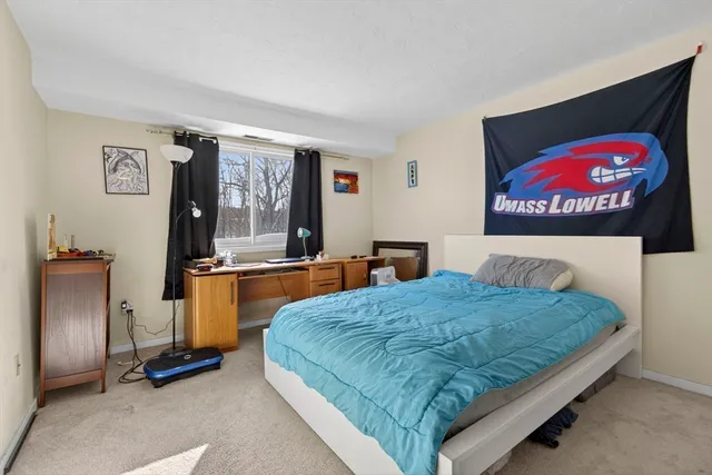 a bedroom with a bed and dresser