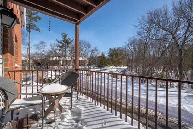 a view of a chairs and table in the balcony