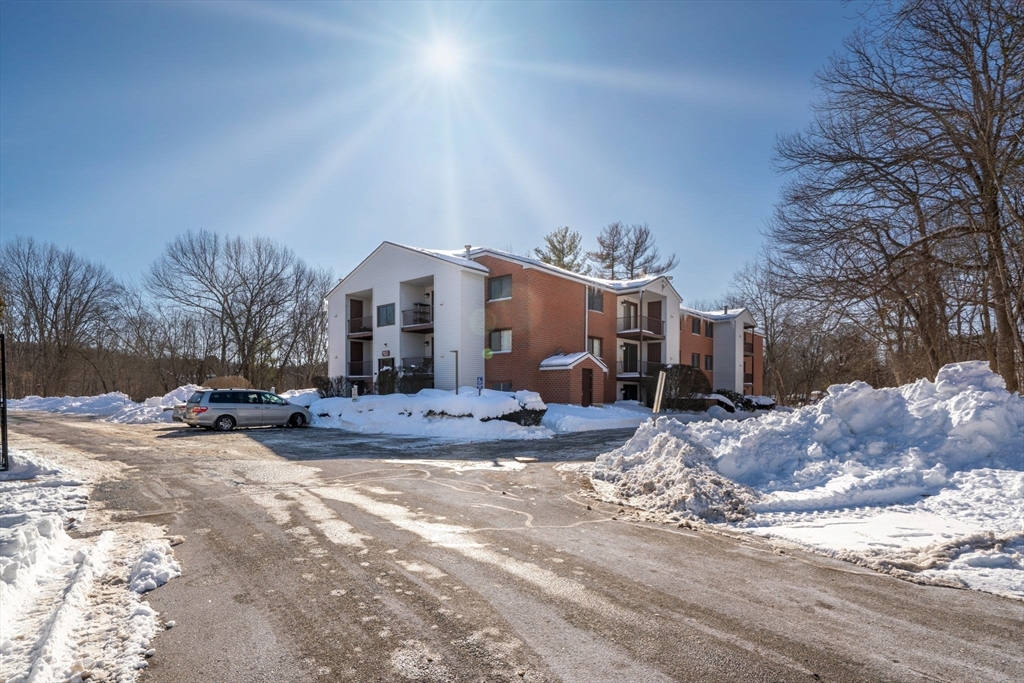 189 Littleton Road, Unit 59 Chelmsford, MA 01824 - Photo 17 of 17 a view of a house with a snow in the yard