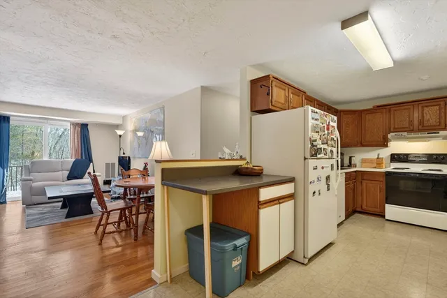 a kitchen with stainless steel appliances granite countertop a stove and a refrigerator