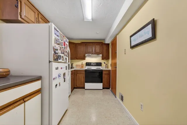 a kitchen with a refrigerator sink and stove top oven