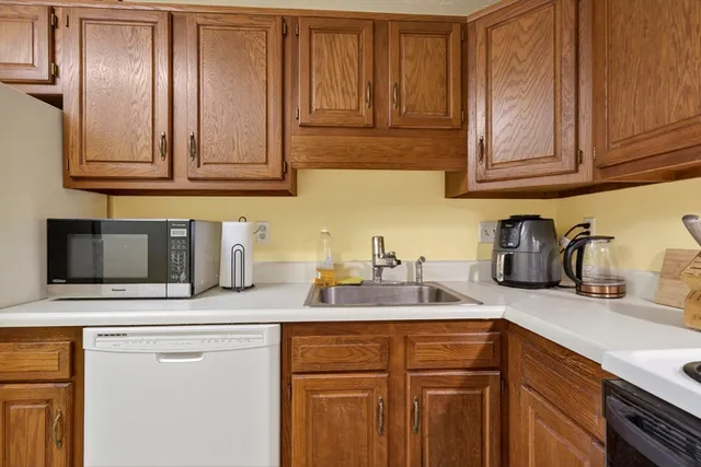 a kitchen with stainless steel appliances granite countertop a sink a stove and cabinets