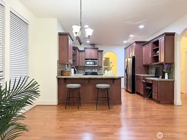 a bathroom with a granite countertop sink a toilet and a mirror