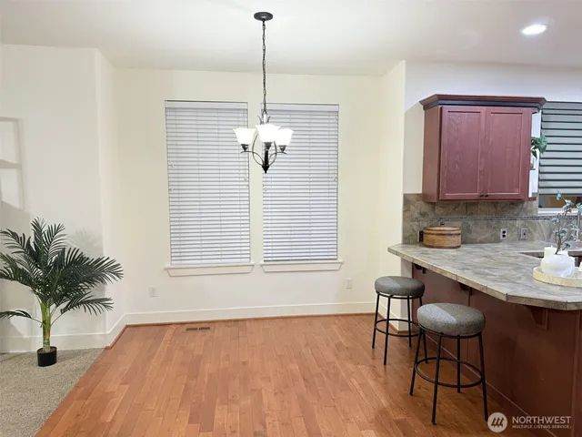 a view of staircase with railing and white walls