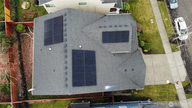 an aerial view of a house with a yard