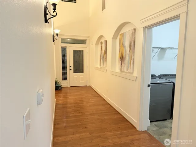 a kitchen with kitchen island granite countertop stainless steel appliances a sink and a refrigerator