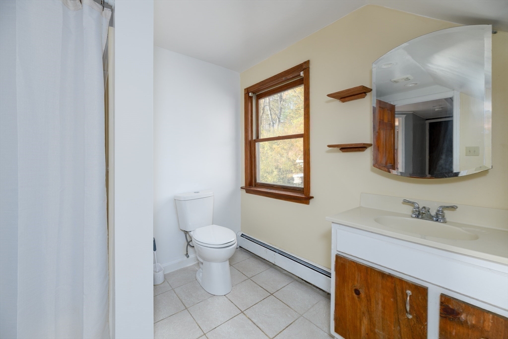 190 Summer Street Barre, MA 01005 - Photo 22 of 25 a bathroom with a toilet sink a mirror and window