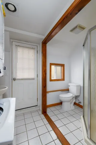 a bathroom with a toilet a sink and shower