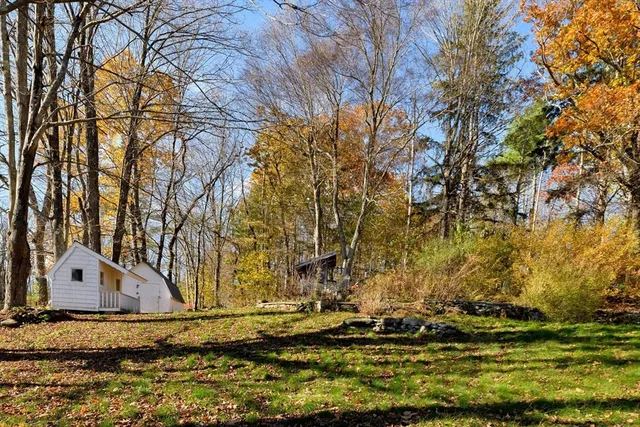a view of a tiny house with a yard