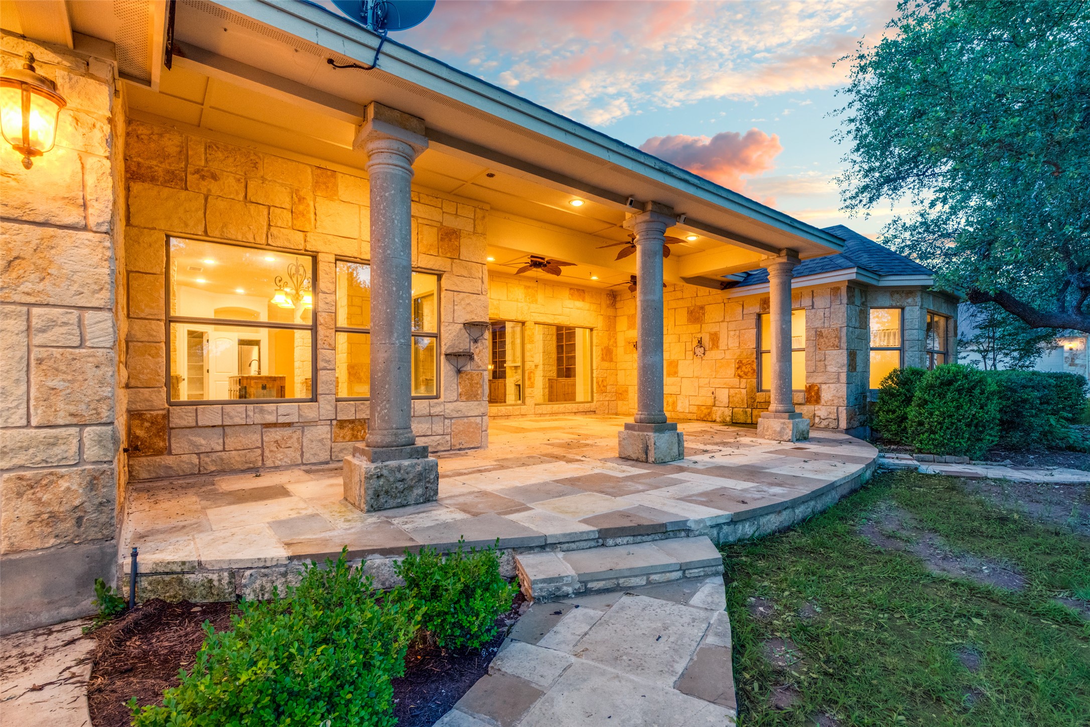 101 Copper Leaf Court Georgetown, TX 78633 - Photo 22 of 31 Stone exterior featuring a covered patio with columnar supports, recessed lighting, and ceiling fans