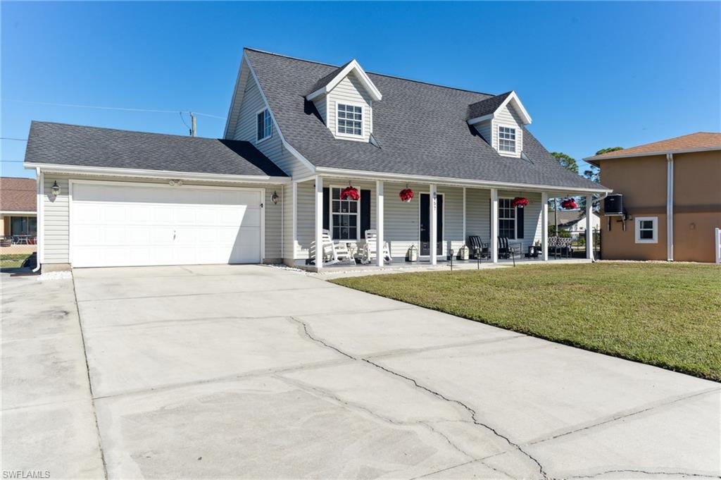 8457 Wren Road Fort Myers, FL 33967 - Photo 13 of 50 Cape cod-style house with a garage, covered porch, and a front yard