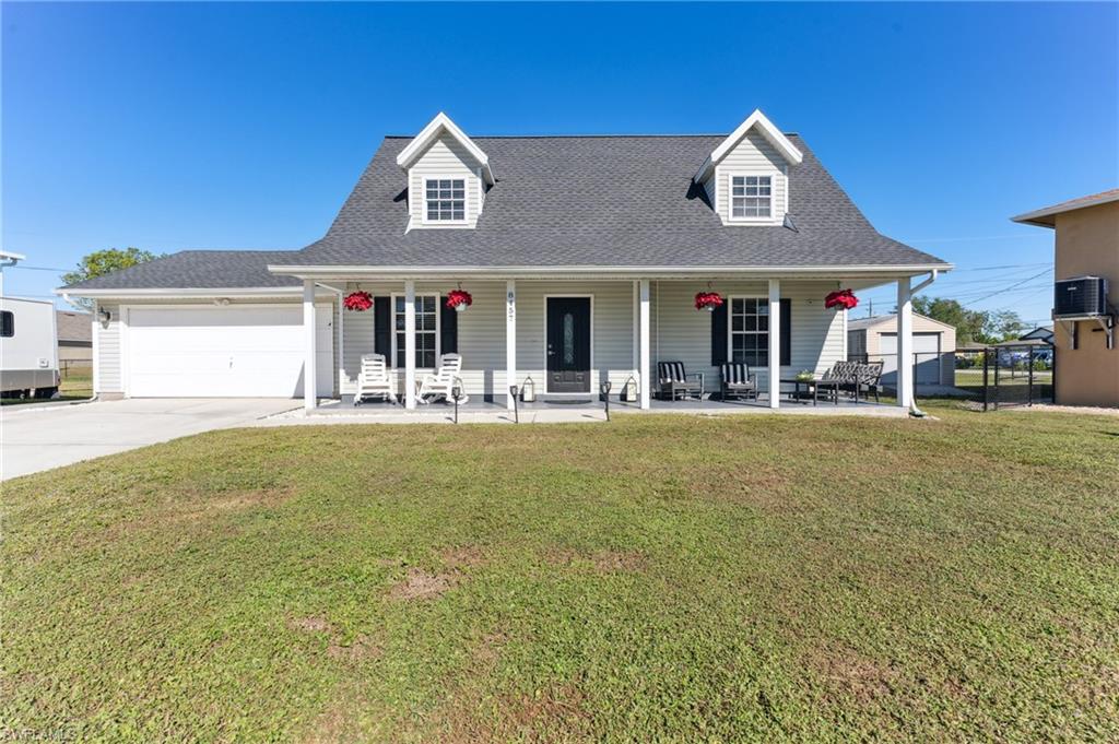 8457 Wren Road Fort Myers, FL 33967 - Photo 14 of 50 Cape cod-style house with a front yard, a porch, a garage, and cooling unit
