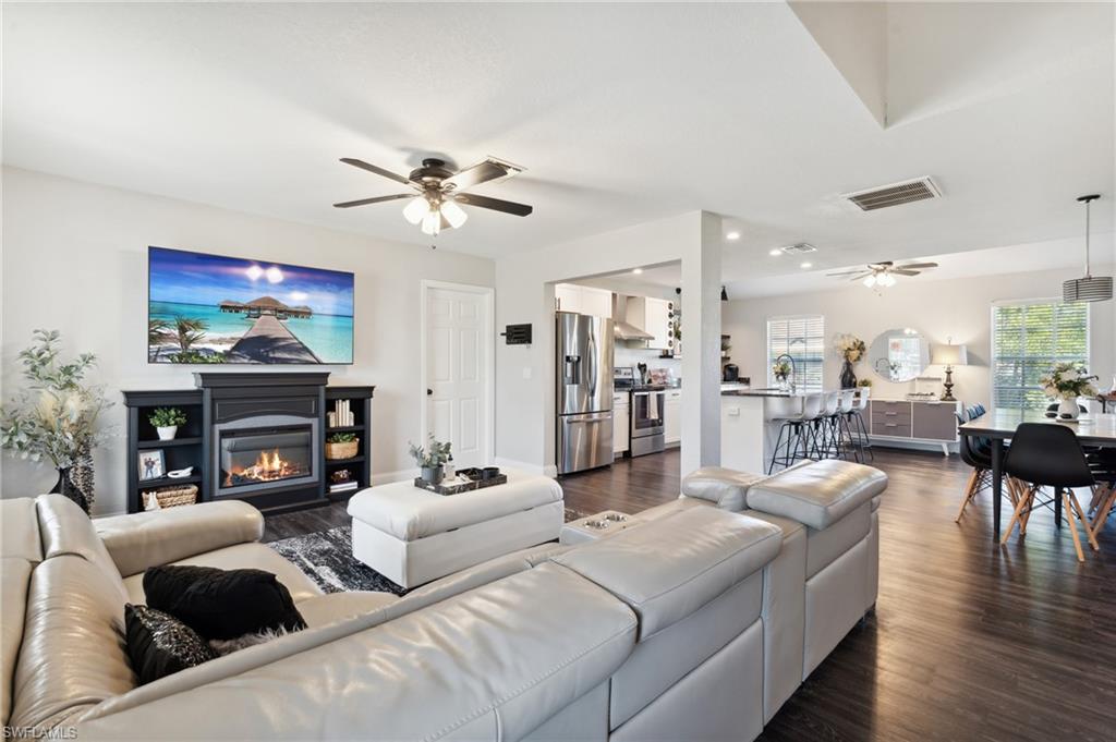 8457 Wren Road Fort Myers, FL 33967 - Photo 17 of 50 Living room with ceiling fan and dark wood-type flooring