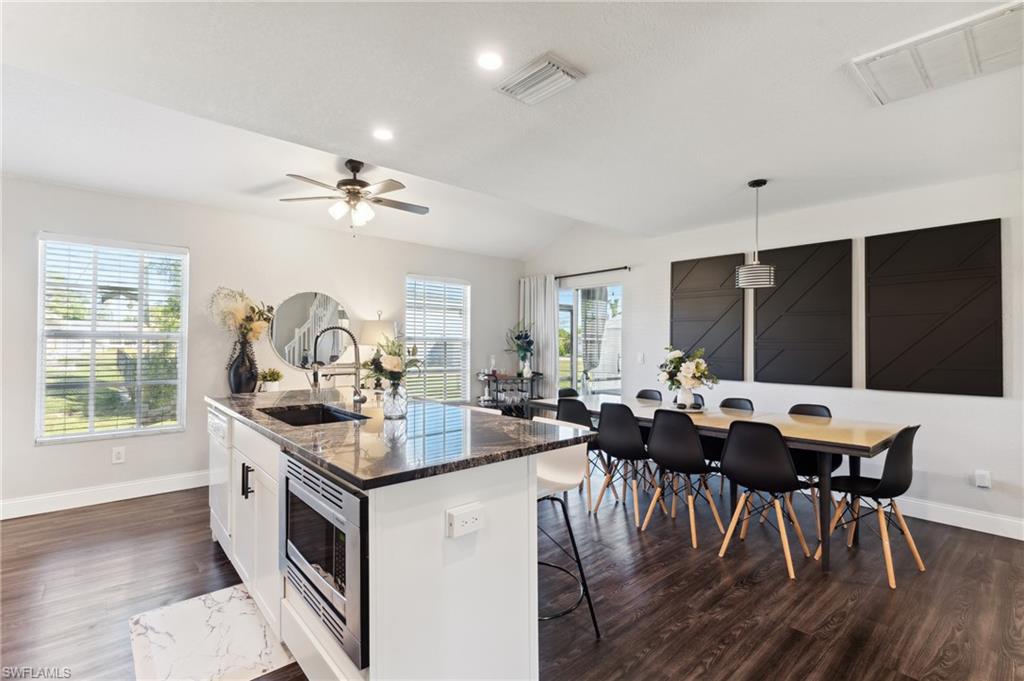 8457 Wren Road Fort Myers, FL 33967 - Photo 18 of 50 Kitchen featuring a healthy amount of sunlight, sink, pendant lighting, and a center island with sink