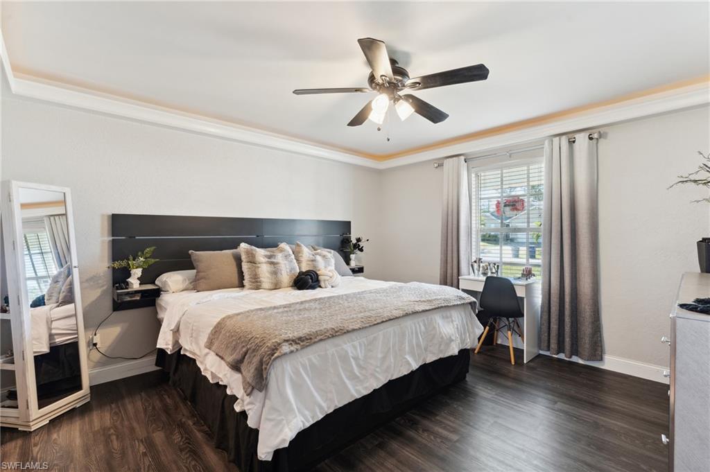 8457 Wren Road Fort Myers, FL 33967 - Photo 24 of 50 Bedroom featuring ceiling fan, dark wood-type flooring, and ornamental molding