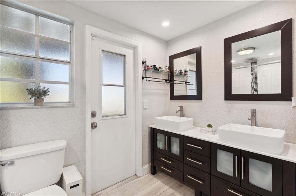 8457 Wren Road Fort Myers, FL 33967 - Photo 26 of 50 Bathroom featuring vanity, hardwood / wood-style flooring, and toilet